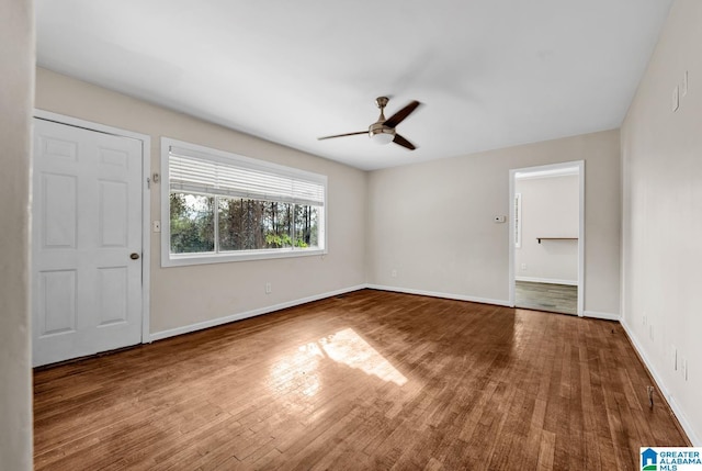 unfurnished room with hardwood / wood-style flooring and ceiling fan