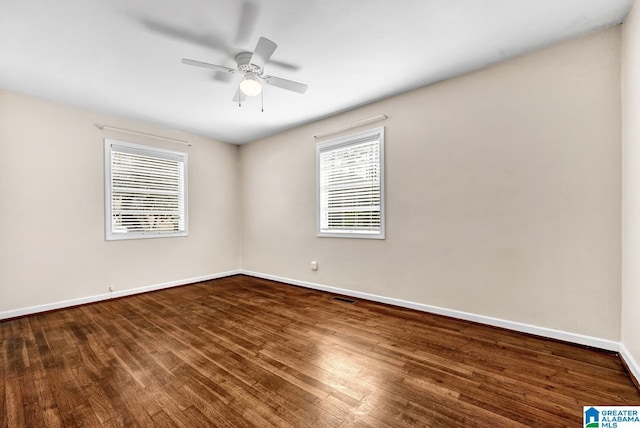 empty room featuring dark hardwood / wood-style floors and ceiling fan