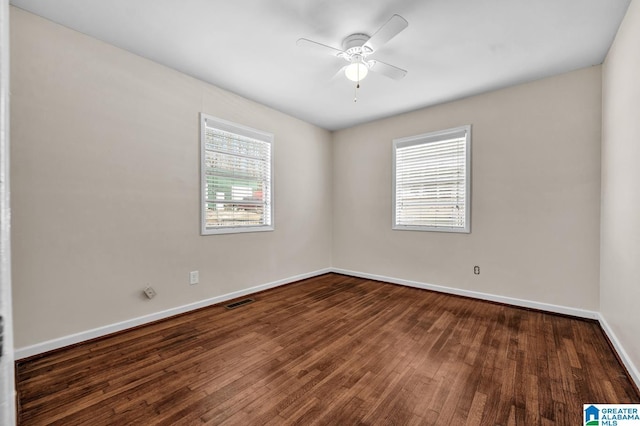 empty room with dark hardwood / wood-style floors and ceiling fan