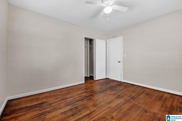 unfurnished bedroom with dark hardwood / wood-style flooring, a closet, and ceiling fan