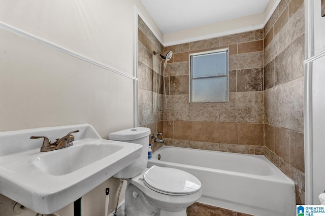 full bathroom with sink, toilet, and tiled shower / bath