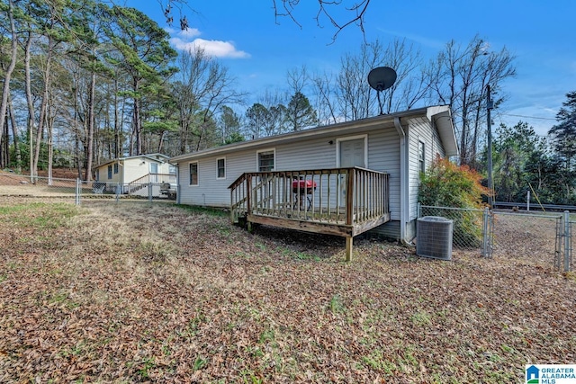 rear view of house featuring cooling unit and a deck