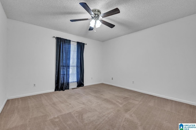 carpeted empty room featuring ceiling fan and a textured ceiling