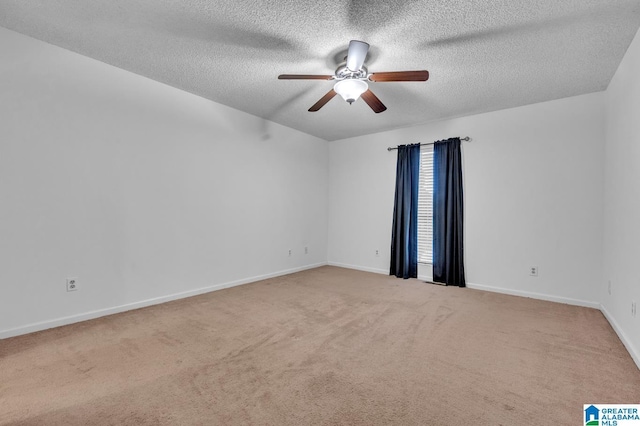 carpeted spare room with ceiling fan and a textured ceiling