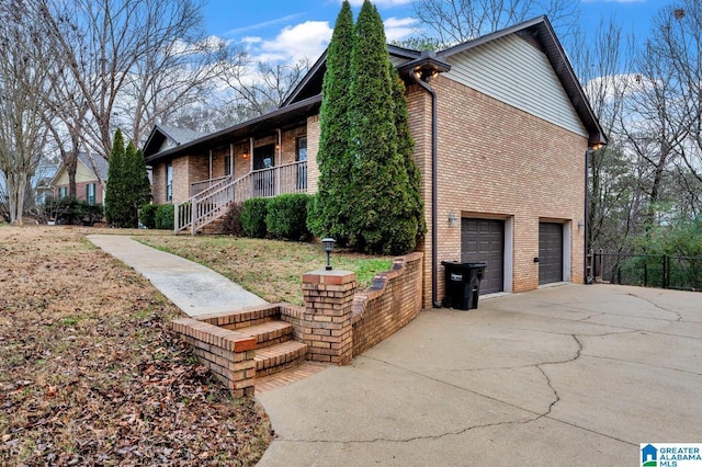 view of property exterior featuring a porch and a garage