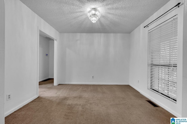 unfurnished bedroom featuring light colored carpet and a textured ceiling