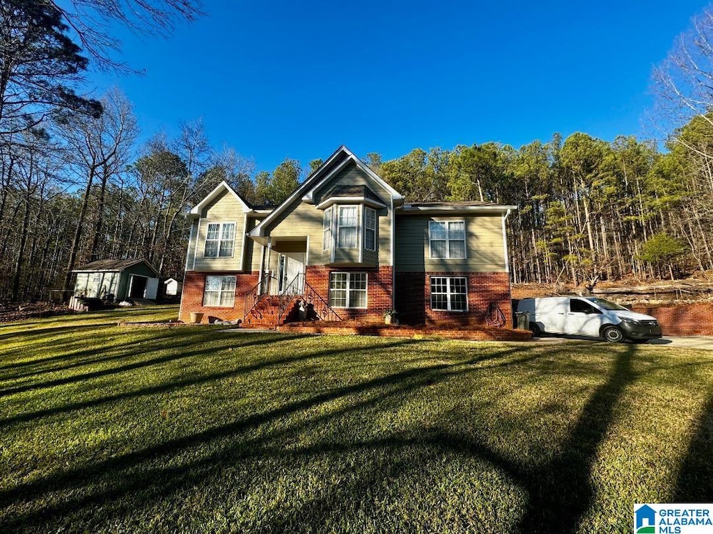 bi-level home with a front lawn