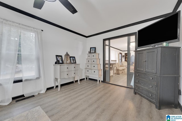 bedroom featuring crown molding, ceiling fan, and light hardwood / wood-style floors