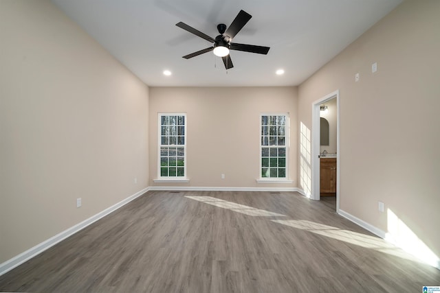 spare room with ceiling fan and hardwood / wood-style flooring