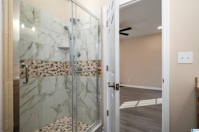 bathroom with vanity, ceiling fan, hardwood / wood-style floors, and an enclosed shower