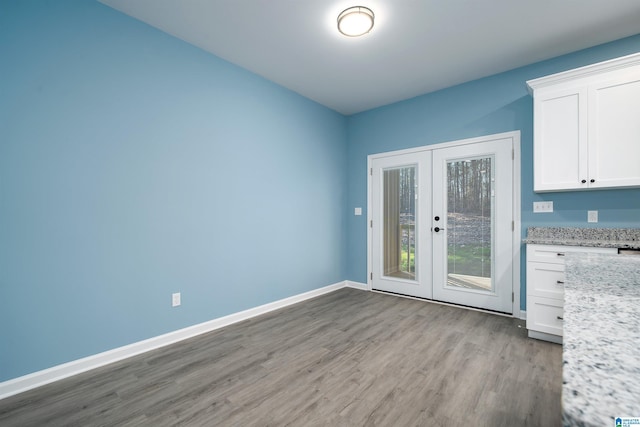 interior space with light wood-type flooring and french doors