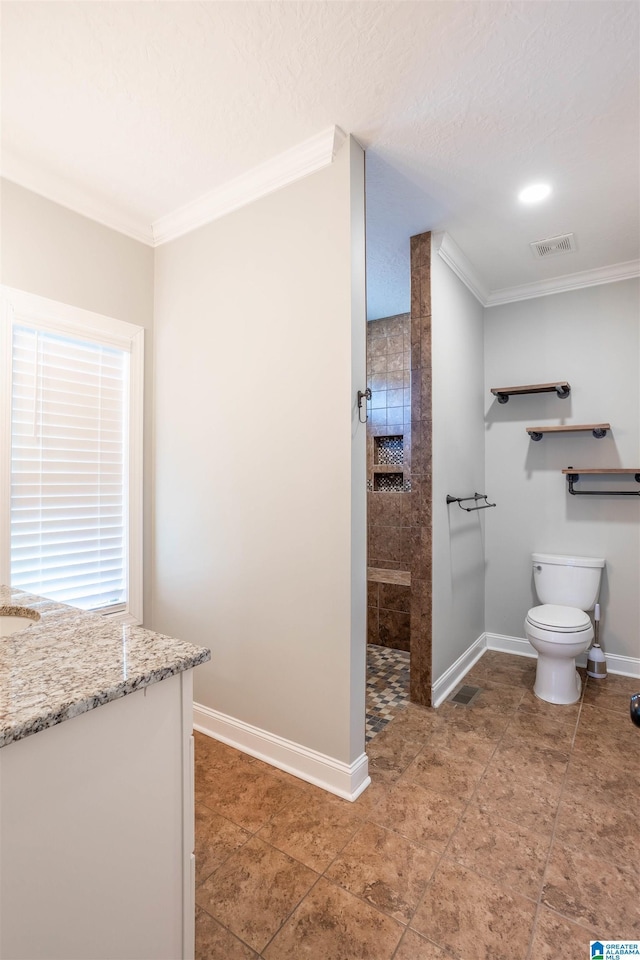 bathroom featuring a shower, toilet, vanity, and ornamental molding