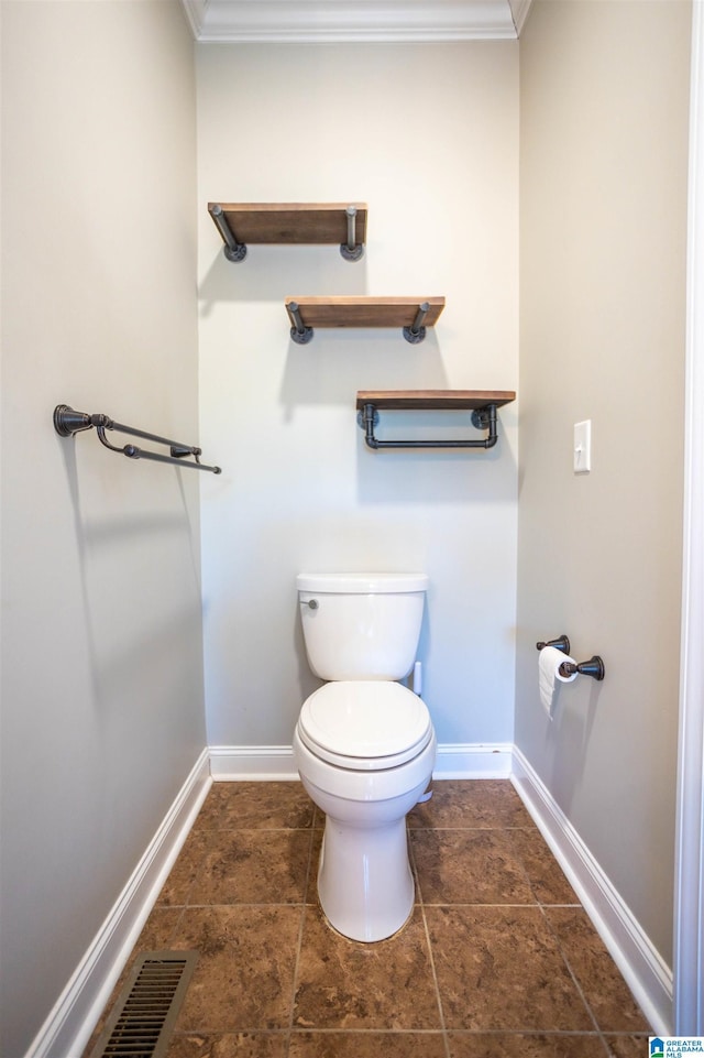 bathroom featuring crown molding and toilet