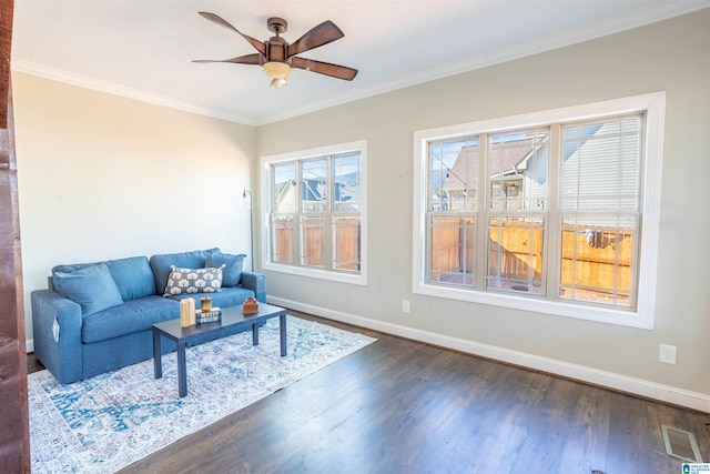 living room featuring crown molding, dark hardwood / wood-style flooring, and ceiling fan