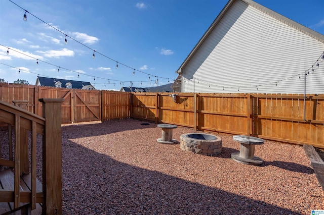 view of yard with a fire pit