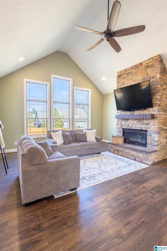 living room featuring a fireplace, dark hardwood / wood-style floors, ceiling fan, and lofted ceiling