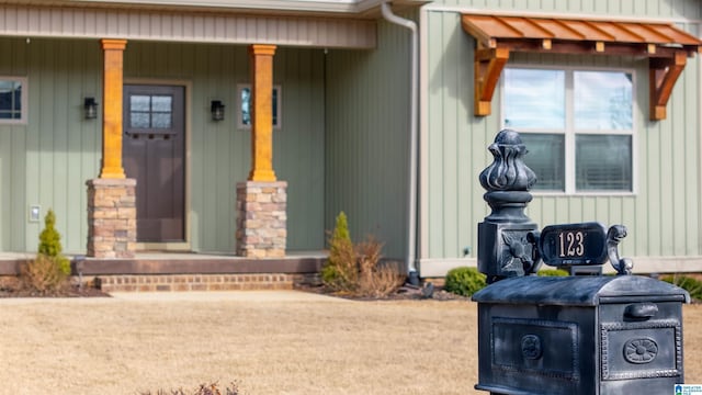 view of exterior entry featuring covered porch