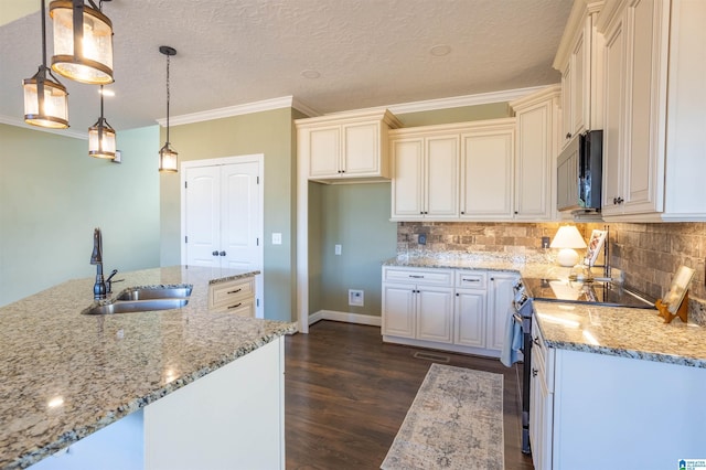 kitchen with backsplash, light stone counters, sink, electric range, and hanging light fixtures