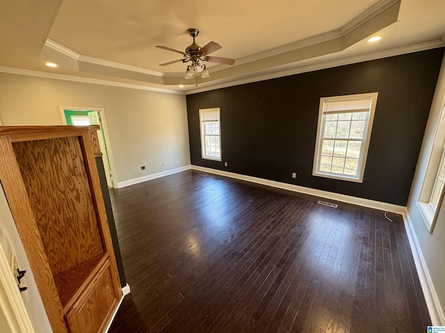 unfurnished room featuring plenty of natural light, crown molding, and a tray ceiling