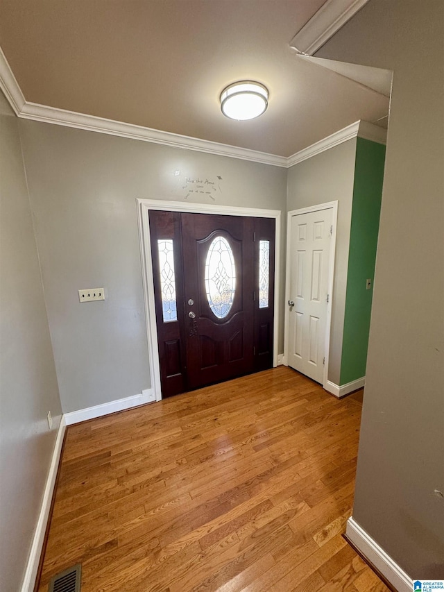 entrance foyer featuring light wood-type flooring and ornamental molding