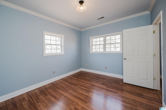 spare room featuring ornamental molding and dark wood-type flooring