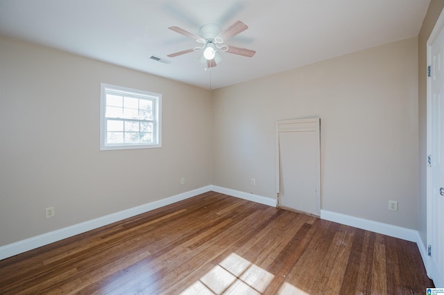 spare room with ceiling fan and wood-type flooring