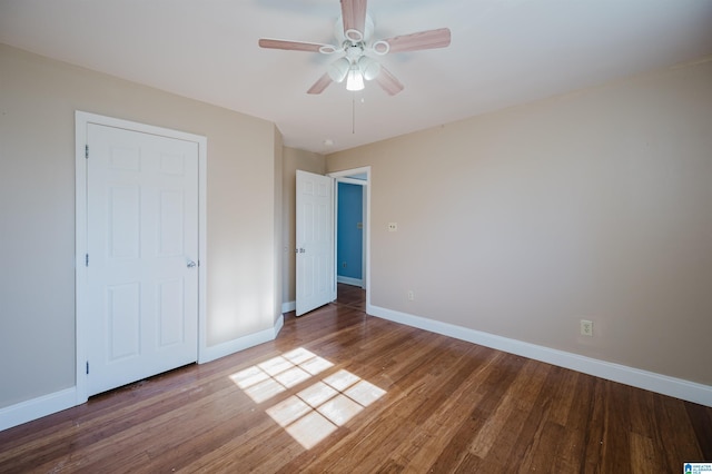 unfurnished bedroom featuring ceiling fan and hardwood / wood-style flooring