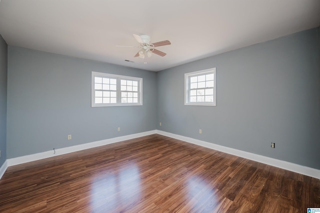 empty room featuring ceiling fan and dark hardwood / wood-style floors