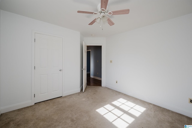 unfurnished bedroom with light colored carpet and ceiling fan