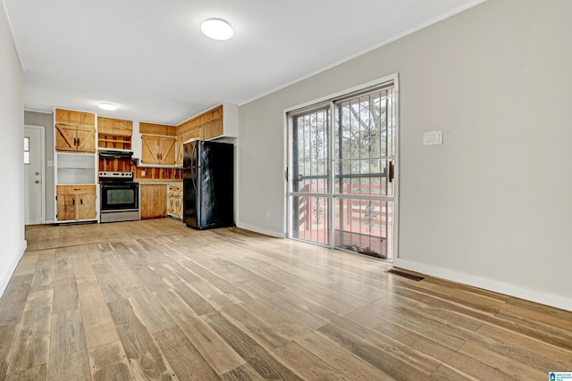 kitchen featuring ventilation hood, black refrigerator, light hardwood / wood-style flooring, electric range, and ornamental molding