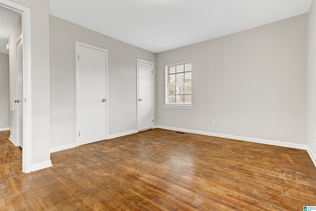 unfurnished bedroom with hardwood / wood-style floors