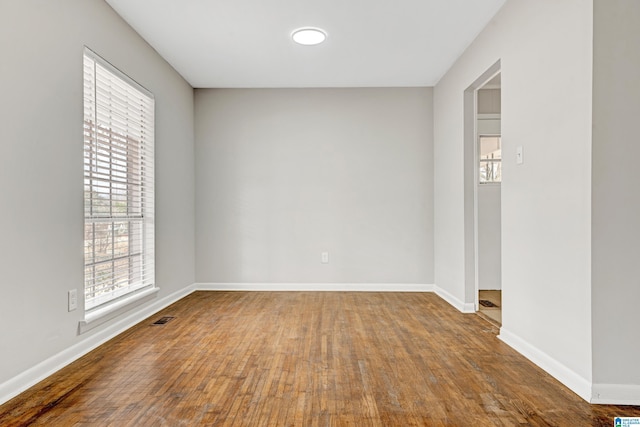 unfurnished room with hardwood / wood-style flooring