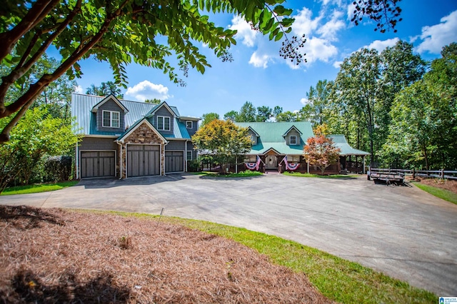 395 Creek Run Rd, Wedowee, AL 36278 - view of front of property with metal roof, stone siding, a garage, and driveway