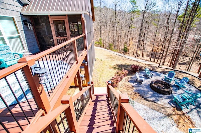 395 Creek Run Rd, Wedowee, AL 36278 - deck featuring stairs, a fire pit, a forest view, and a sunroom