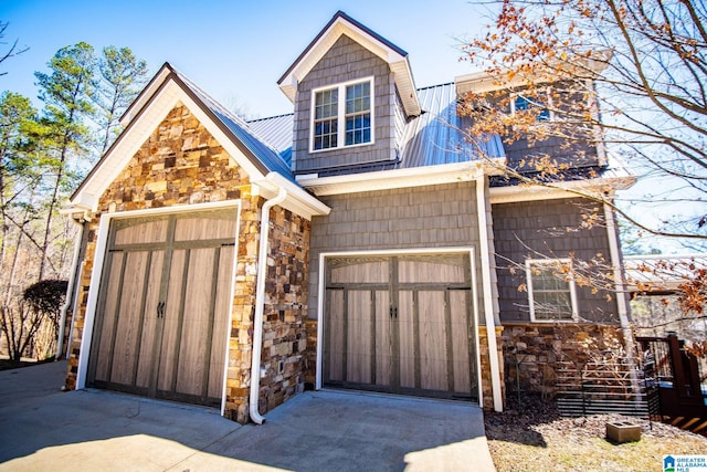 395 Creek Run Rd, Wedowee, AL 36278 - view of front facade featuring concrete driveway, stone siding, and metal roof