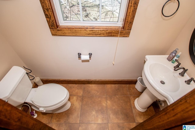 395 Creek Run Rd, Wedowee, AL 36278 - half bath with tile patterned flooring, toilet, baseboards, and a sink