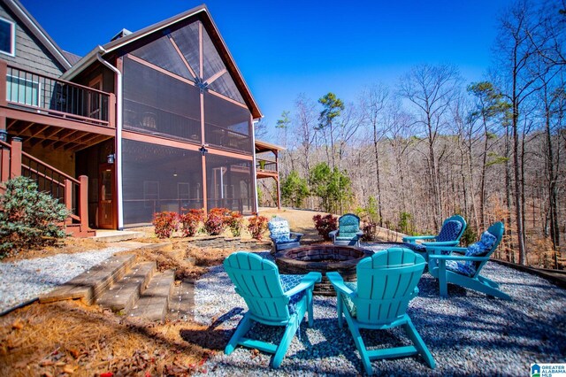 395 Creek Run Rd, Wedowee, AL 36278 - exterior space with a sunroom, a wooded view, and an outdoor fire pit
