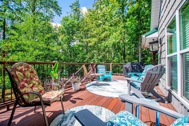 wooden terrace featuring a grill