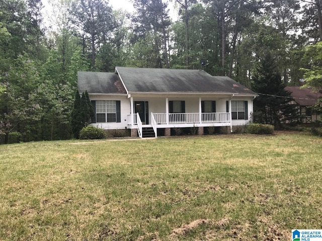 ranch-style home with a front yard and covered porch