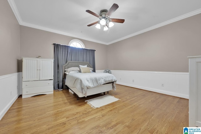 bedroom with ceiling fan, crown molding, and light hardwood / wood-style floors