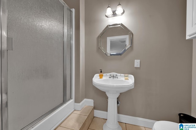 bathroom featuring tile patterned flooring, an enclosed shower, and toilet