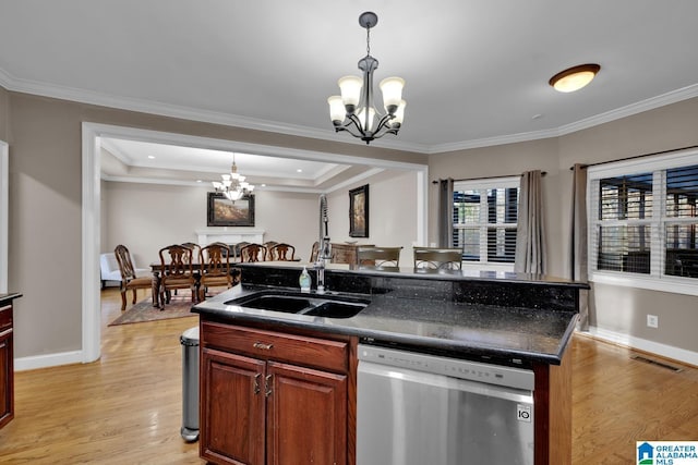 kitchen with stainless steel dishwasher, sink, a kitchen island with sink, and an inviting chandelier