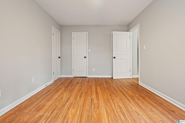 unfurnished bedroom with light wood-type flooring