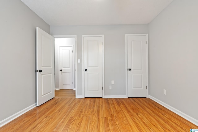 unfurnished bedroom featuring light wood-type flooring