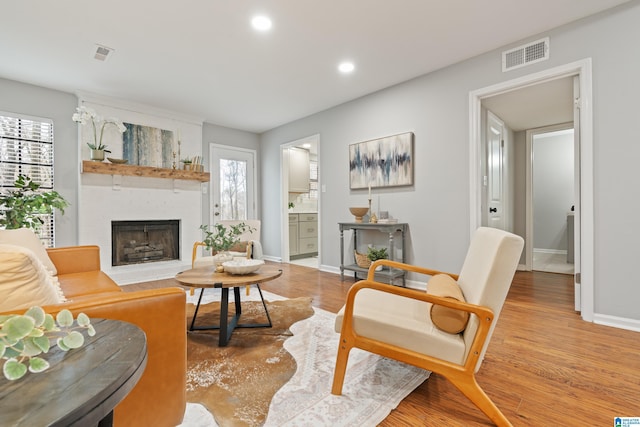 living room featuring hardwood / wood-style floors and a brick fireplace