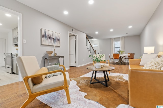 living room with light hardwood / wood-style flooring