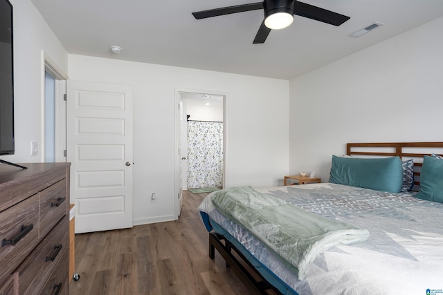 bedroom featuring wood-type flooring, ceiling fan, and connected bathroom