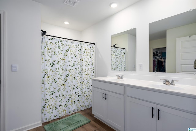 bathroom with vanity and hardwood / wood-style flooring