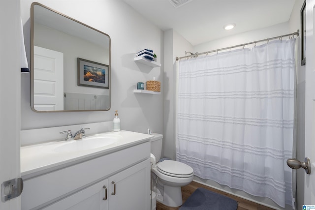 bathroom featuring hardwood / wood-style floors, a shower with curtain, vanity, and toilet