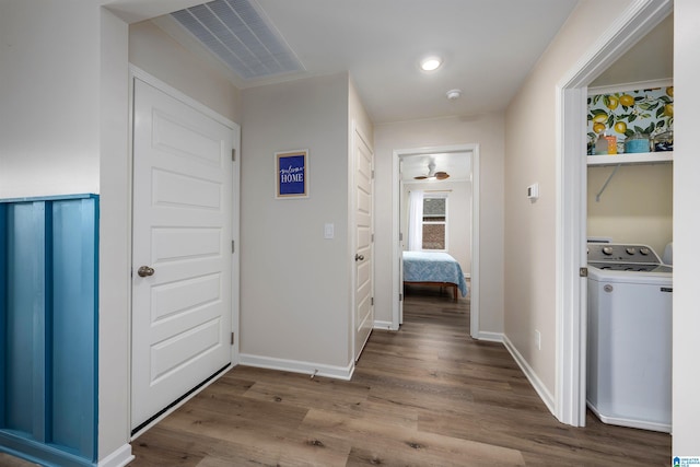 hall with light wood-type flooring and washer / dryer